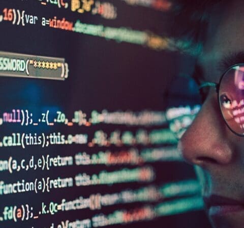 Hacker using computer, smartphone and coding to steal password and private data